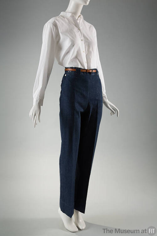 Blue denim jeans, creased at center leg, dressed with white buttoned shirt and brown belt