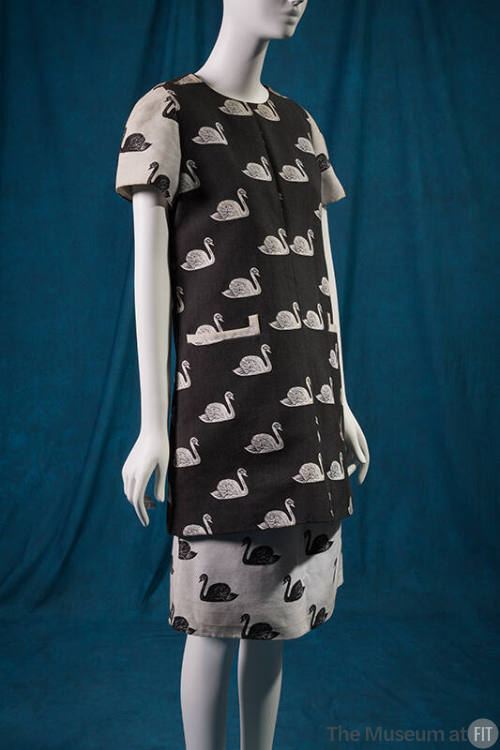 Black tunic with jacquard pattern of white swans and contrasting white short sleeves and knee l…