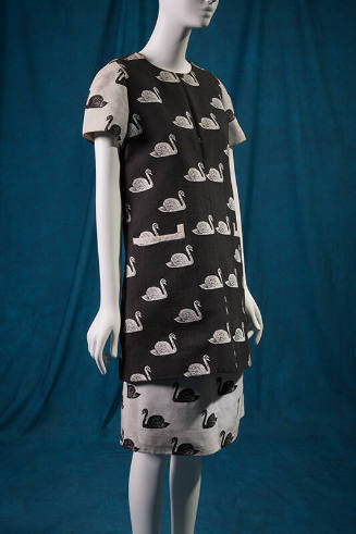 Black tunic with jacquard pattern of white swans and contrasting white short sleeves and knee l…