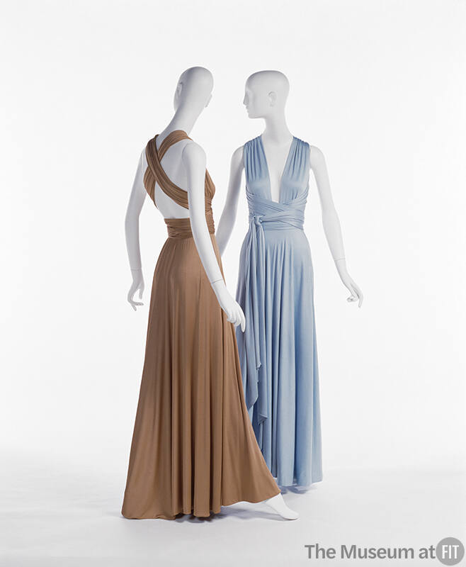 Back view of floor length copper dress with ties crisscrossed across the back and light blue fl…