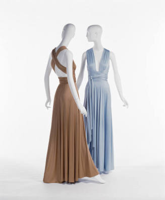 Back view of floor length copper dress with ties crisscrossed across the back and light blue fl…