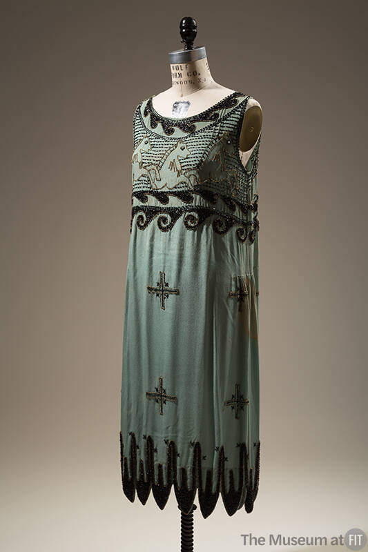 Short turquoise blue sleeveless sheath dress with black jet and gold seed beads on bodice in sc…