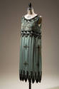 Short turquoise blue sleeveless sheath dress with black jet and gold seed beads on bodice in sc…