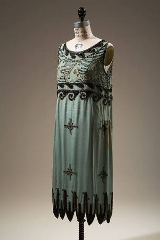 Short turquoise blue sleeveless sheath dress with black jet and gold seed beads on bodice in sc…