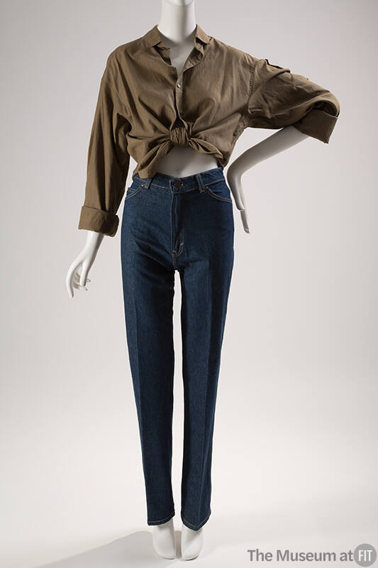 Dark blue denim jeans styled with brown button down top tied at waist
