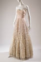 Strapless floor length pale pink ballgown, white feathers stitched on full circle skirt to crea…