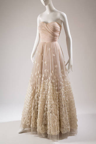 Strapless floor length pale pink ballgown, white feathers stitched on full circle skirt to crea…