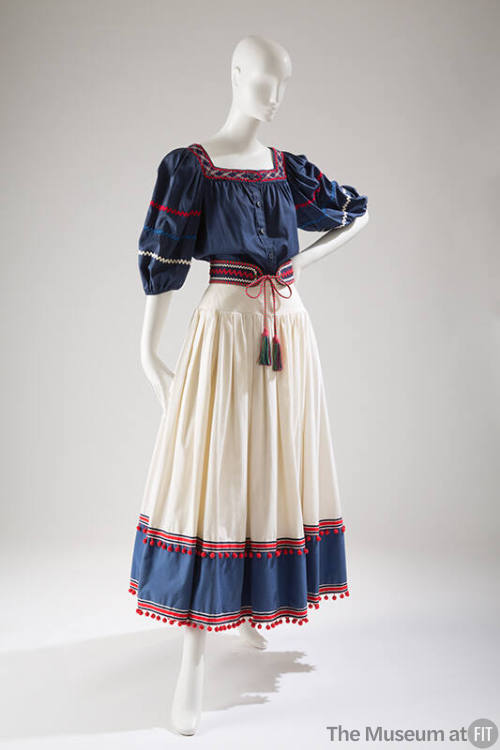 Two-piece dress, navy top with elbow length sleeves and red trim, white skirt with navy band an…