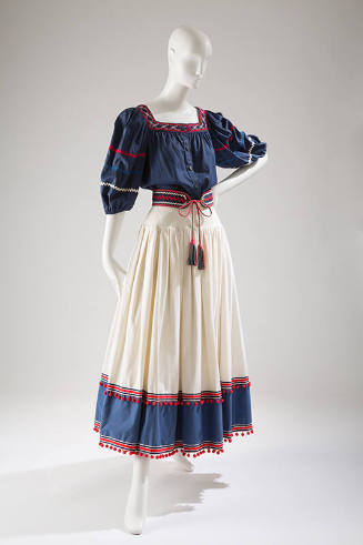 Two-piece dress, navy top with elbow length sleeves and red trim, white skirt with navy band an…
