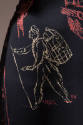 Sketch of person hiking with backpack in cream against black fabric