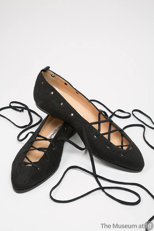 Black ballet flats with full length lacings extending to ankle wrap, hidden wedge