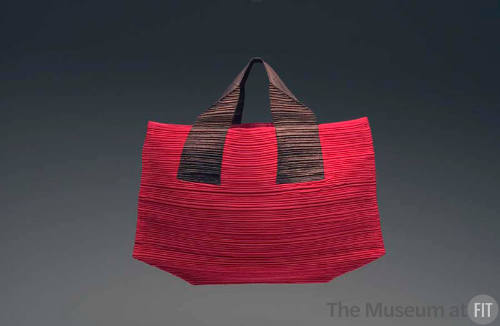 Red tote bag with brown handles, horizontally pleated