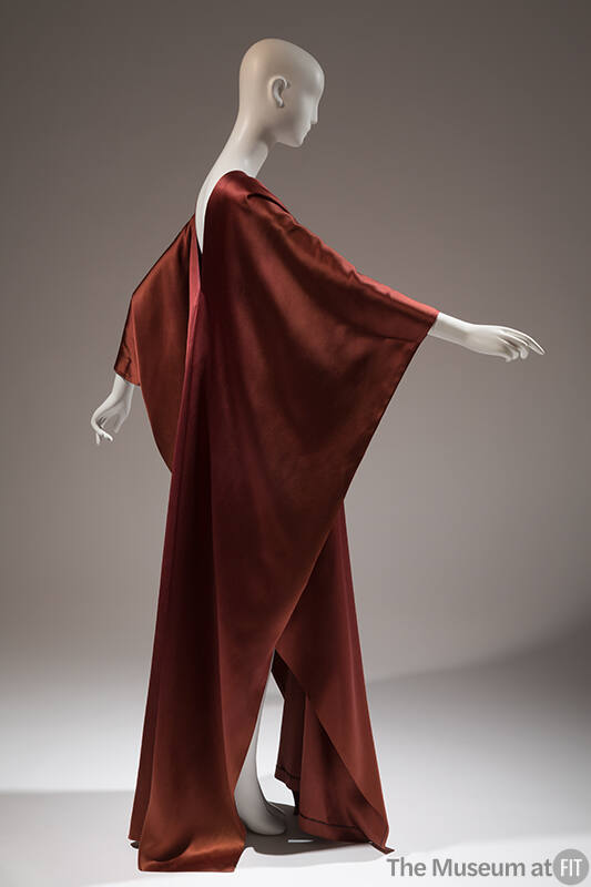 Side view of rust brown satin floor length caftan style evening dress 