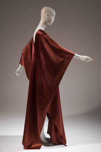 Side view of rust brown satin floor length caftan style evening dress 