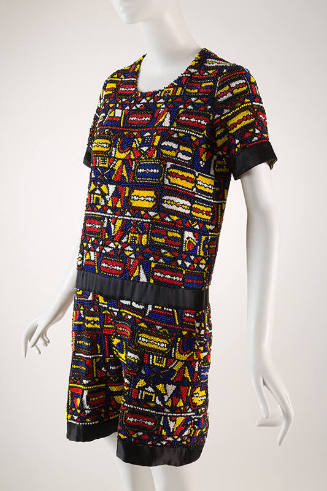 Red, yellow, blue, white and black fully beaded shorts jumpsuit, short sleeves, black satin tri…