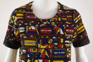 Detail shot of red, yellow, blue, white and black fully beaded scoop neck, short sleeves with b…