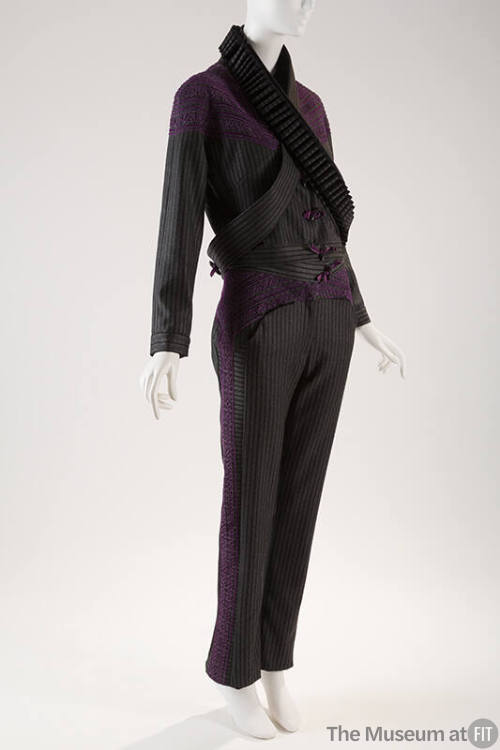 Grey and black striped pantsuit with purple applique across shoulders and down sides of pant le…