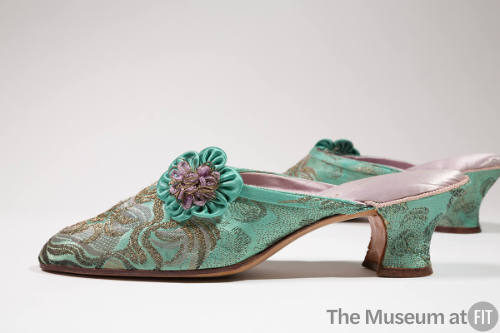 Pair of green and gold metallic brocade mules with low heel and green and purple appliqued flow…