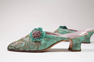 Pair of green and gold metallic brocade mules with low heel and green and purple appliqued flow…
