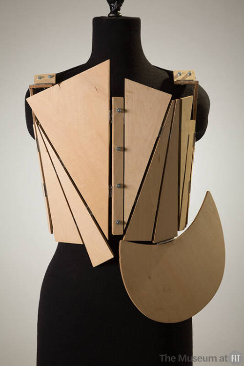 Corset made of triangular pieces of wood attached with nuts and bolts 