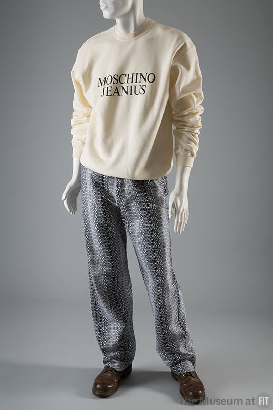 Off-white long sleeve sweatshirt with text Moschino Jeanius on front and denim jeans with allov…