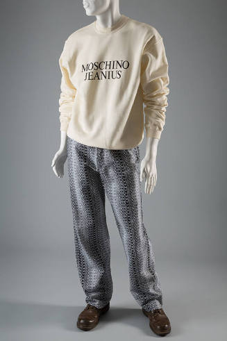 Off-white long sleeve sweatshirt with text Moschino Jeanius on front and denim jeans with allov…