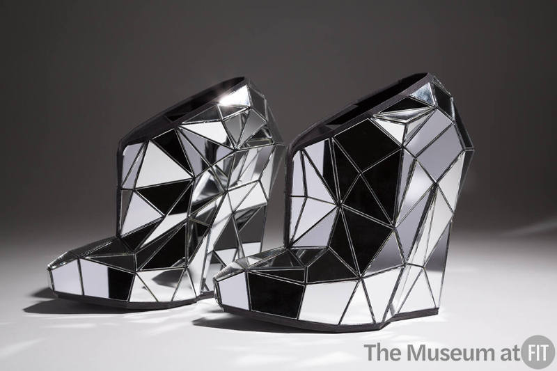 Platform shoes covered with fractured, laser cut mirror pieces