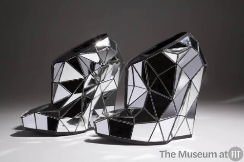 Platform shoes covered with fractured, laser cut mirror pieces