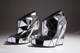 Platform shoes covered with fractured, laser cut mirror pieces