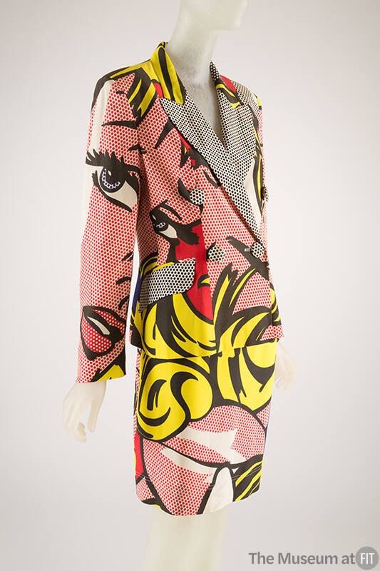 Suit jacet and skirt in blown up comic strip print of woman's face in red, neon, yellow, black,…