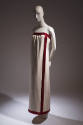Ivory strapless floor length evening dress with deep red beaded and embroidered edge band at ne…