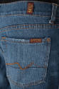 Detail view of blue denim jeans showing orange zigzag stitching on back pocket, orange topstitc…