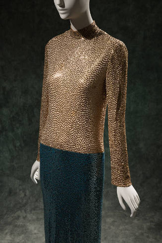 ¾ view of full length color blocked sequined dress with gold sequins on long sleeve stand colla…