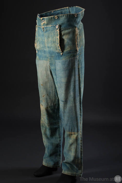 Man’s blue denim trousers with button closure drop front, buttons along waistline and patches a…