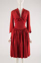 Red knee-length dress with pleated skirt and long bell sleeves and tie panels that knot at cent…
