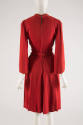 Back view of red dress showing zipper back, tie around waist and bell sleeves