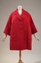 Wide red thigh-length coat with 7/8 sleeves and two large front patch pockets