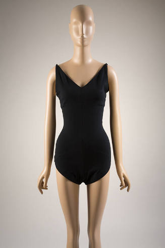 Black fitted V-neck bathing suit with tapered shoulder straps and full coverage bottoms
