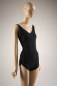 Black fitted V-neck bathing suit with tapered shoulder straps and full coverage bottoms