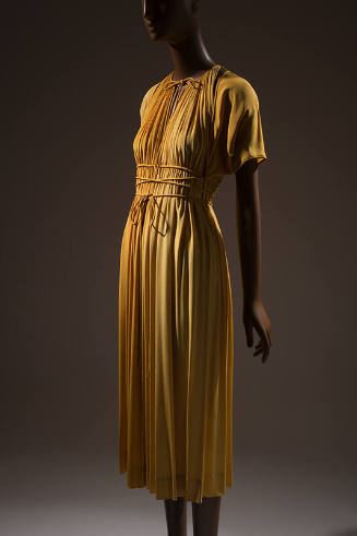 Deep gold evening dress and bolero; sleeveless dress gathered at the neck with tie