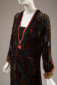 Black long sleeve dress with multicolor geometric velvet pattern, pink ribbon trimmed V-neck wi…