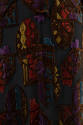 Textile detail: geometric shield and square velvet pattern in gold, brown, red, purple, blue on…