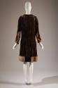 Back of black with mulitcolor velvet geometric pattern long sleeve dress; fur cuffs and hem tri…