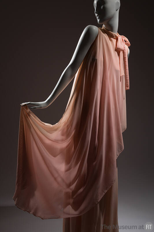 Pink sleeveless floor length evening dress with high neckline tied in bow at right neck and top…