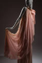 Pink sleeveless floor length evening dress with high neckline tied in bow at right neck and top…