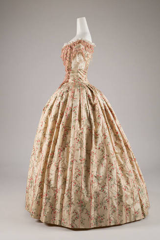 Side view of two-piece floor length dress in pale green with green, grey and red floral print, …