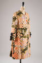 White linen coat printed with winged animal design in black, gold, mauve pink interspersed with…