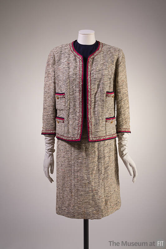 Loosely woven off-white and beige tweed jacket with navy blue and red edging and matching skirt