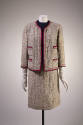 Loosely woven off-white and beige tweed jacket with navy blue and red edging and matching skirt