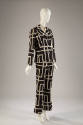 Black jacket, skirt, and pants with quilted texture and large white geometric linear design